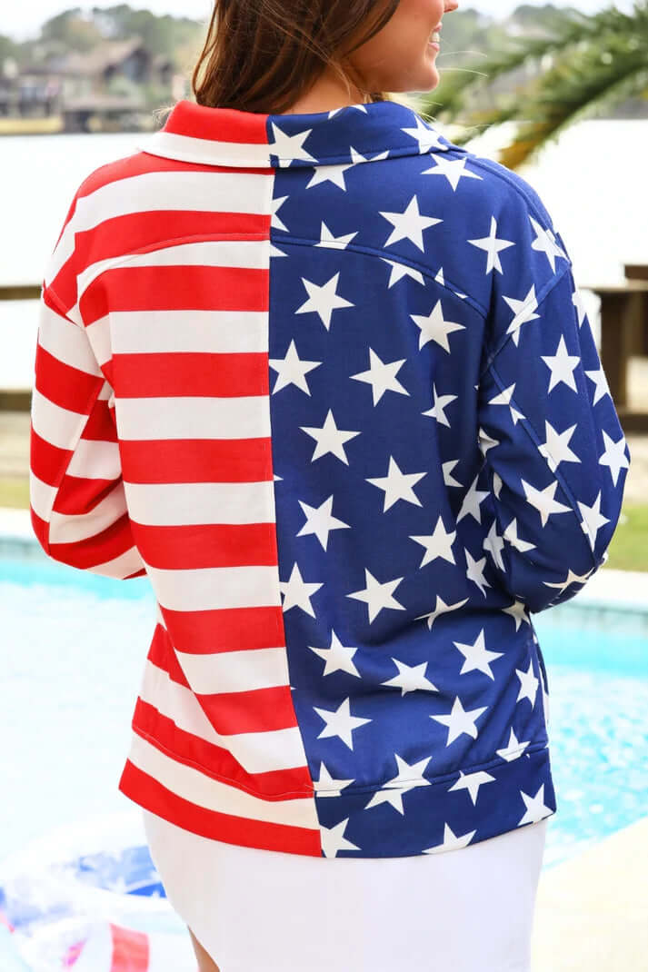 Women wearing an Americana design pullover by a pool.