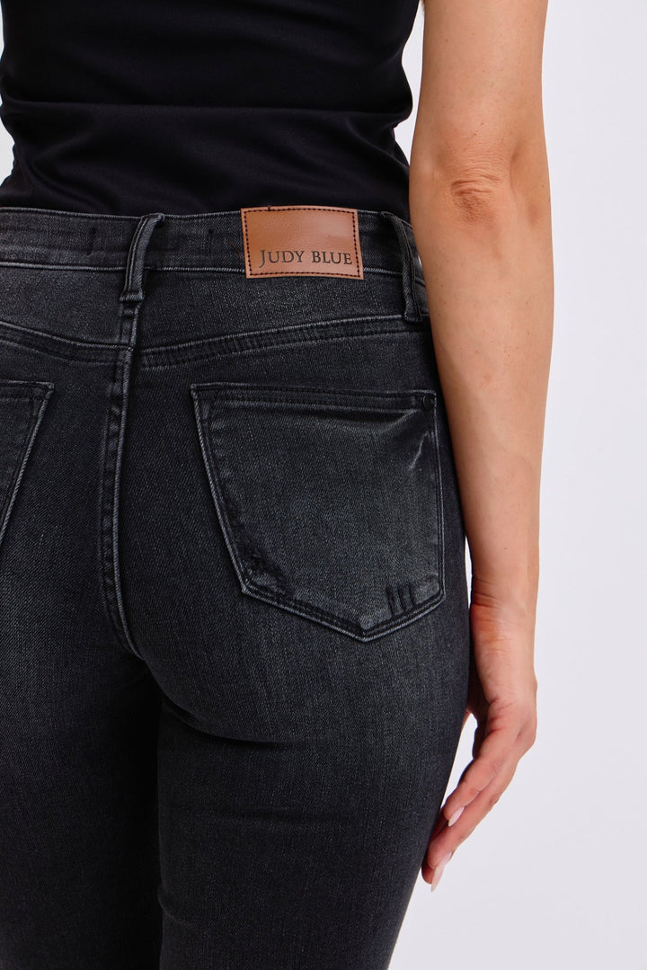 Closeup of the back of a woman wearing black skinny jeans.  Judy Blue Jeans (NP) - Mid Rise Tummy Control Skinny - black | Nikki &amp; Co. Boutique