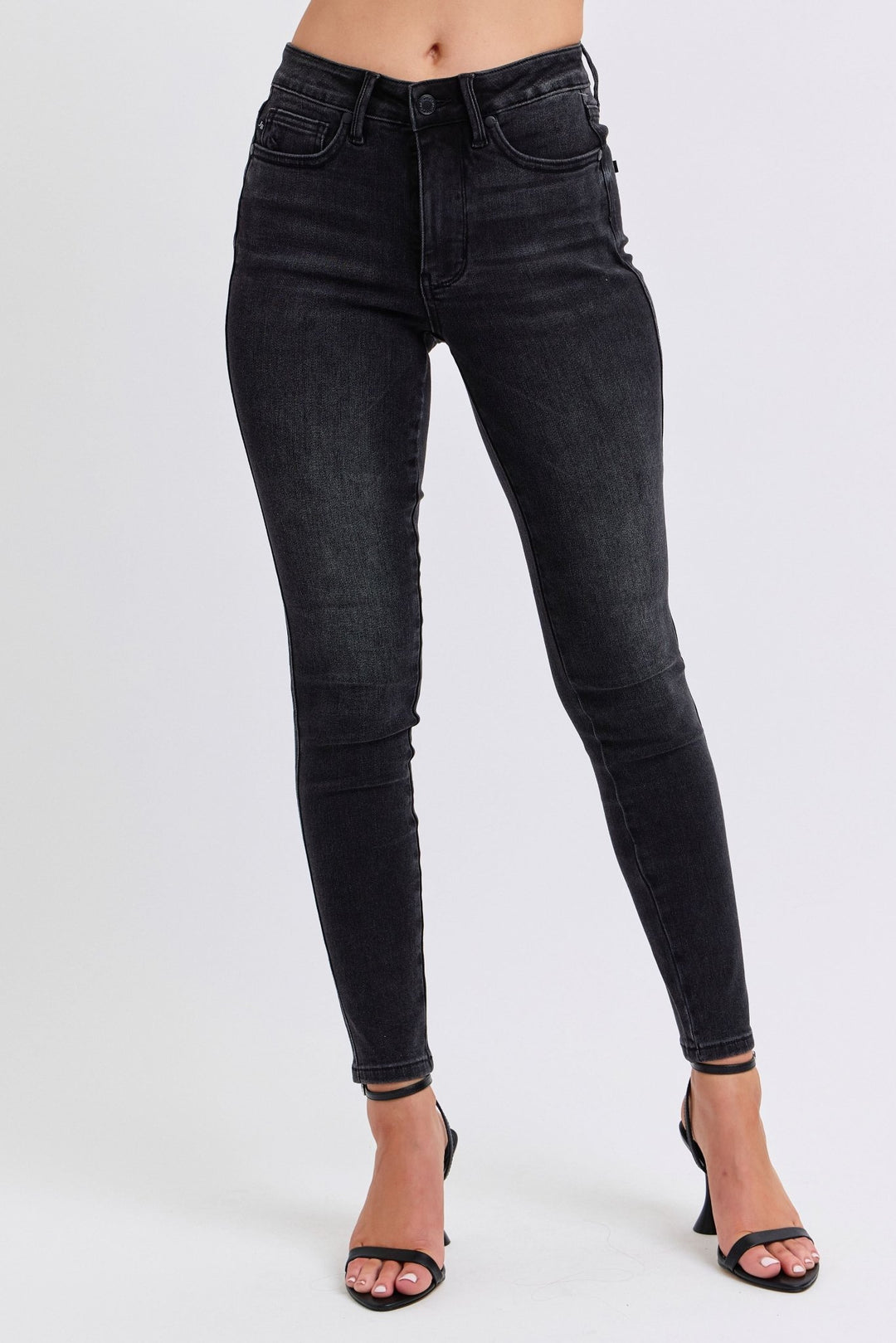 Woman wearing black skinny jeans with white background. Judy Blue Jeans (NP) - Mid Rise Tummy Control Skinny - black | Nikki &amp; Co. Boutique