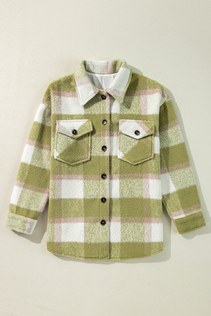 Green and white plaid shirt with button details on a beige background