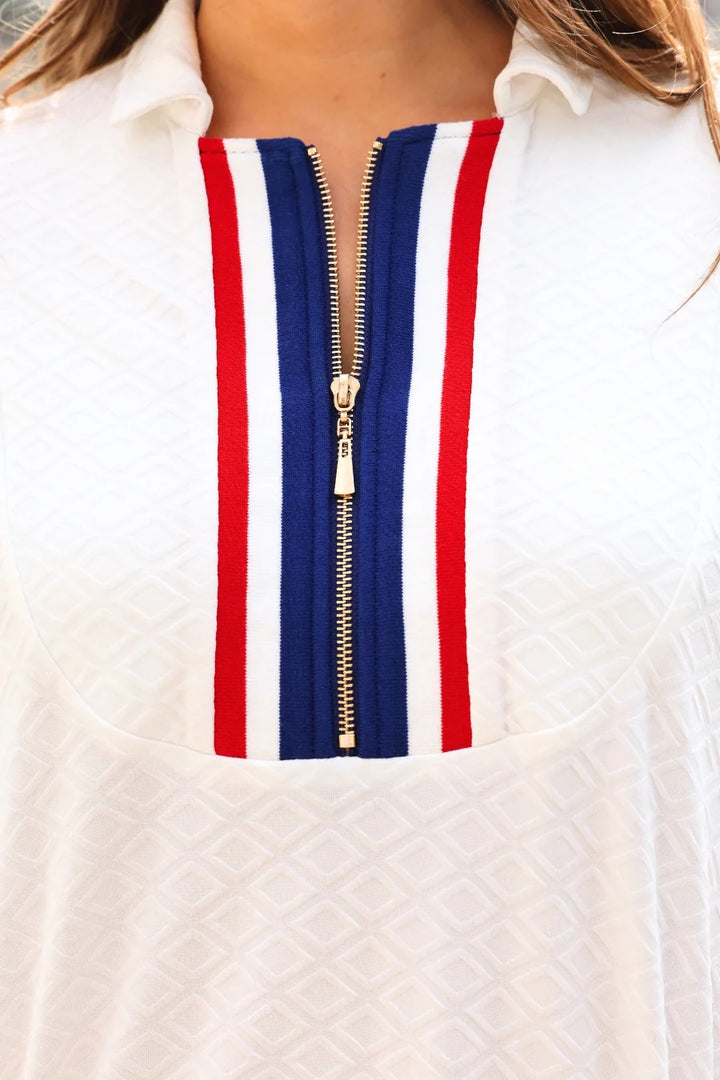 Close-up of a white shirt with a red, white, and blue striped zipper.