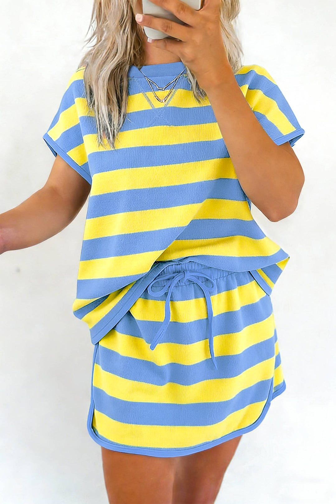 Person wearing a blue and yellow striped set against a white background