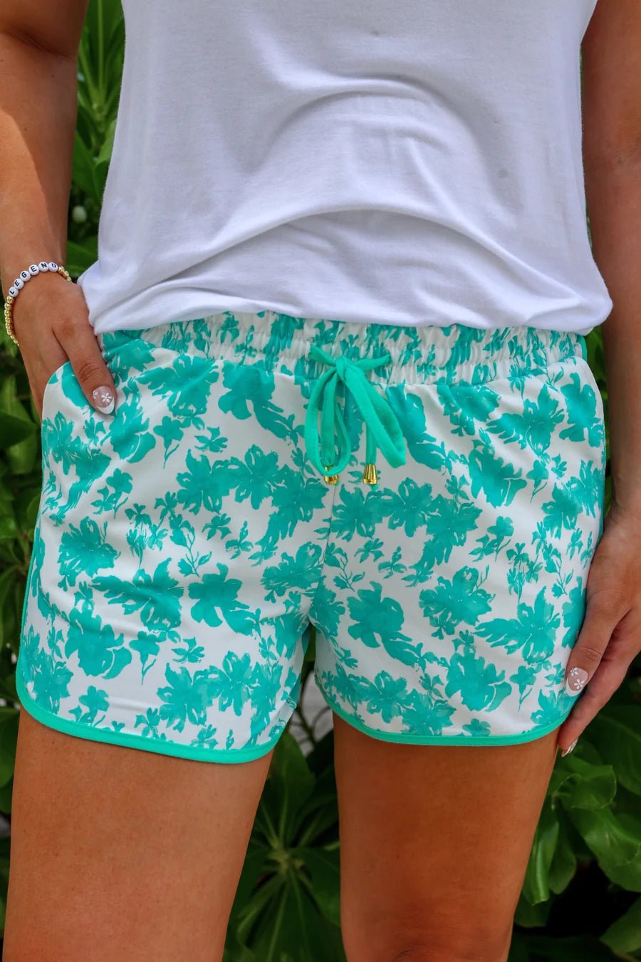 A close up of the shorts with a white short and one hand tucked in