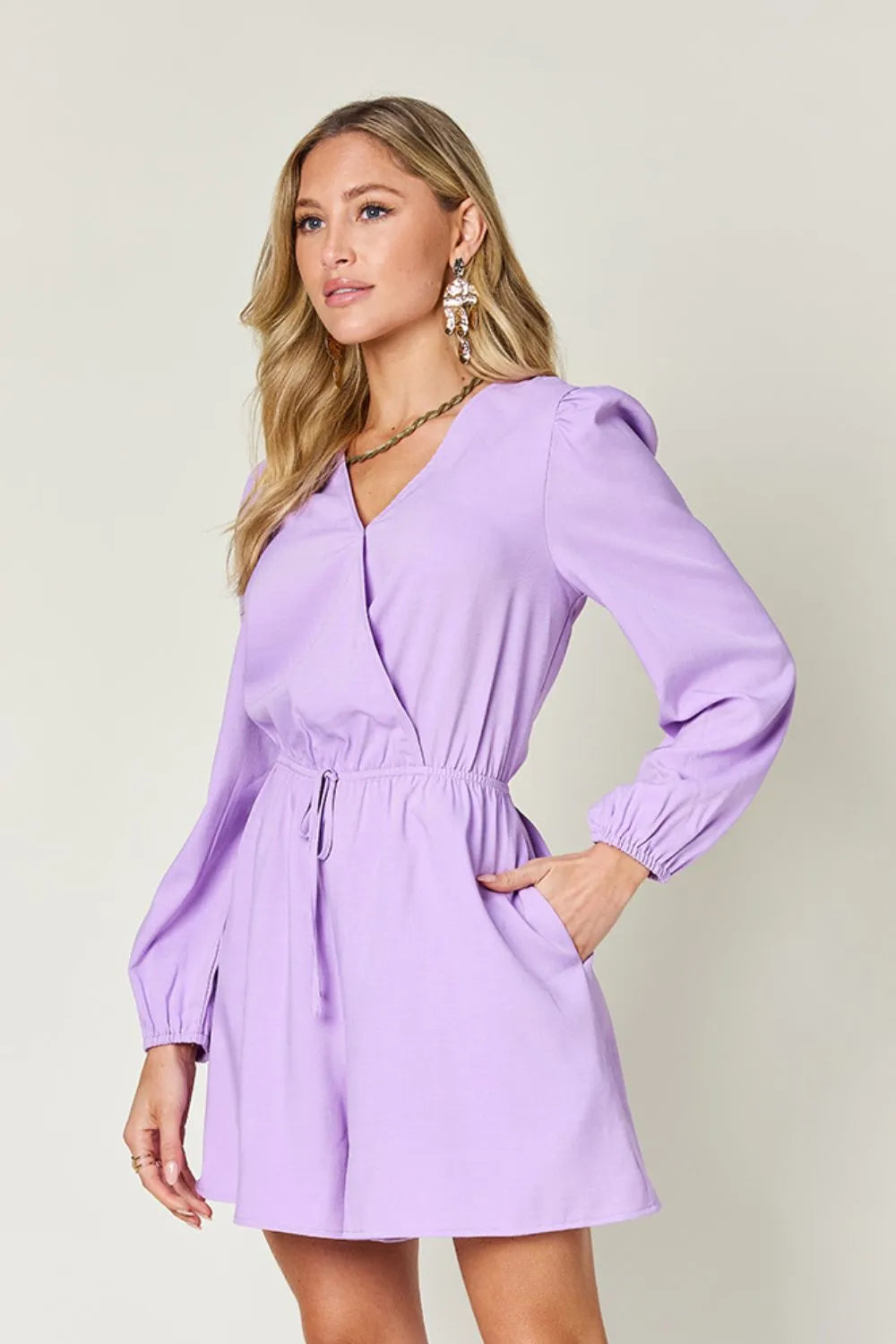 Woman wearing a purple dress against a plain background