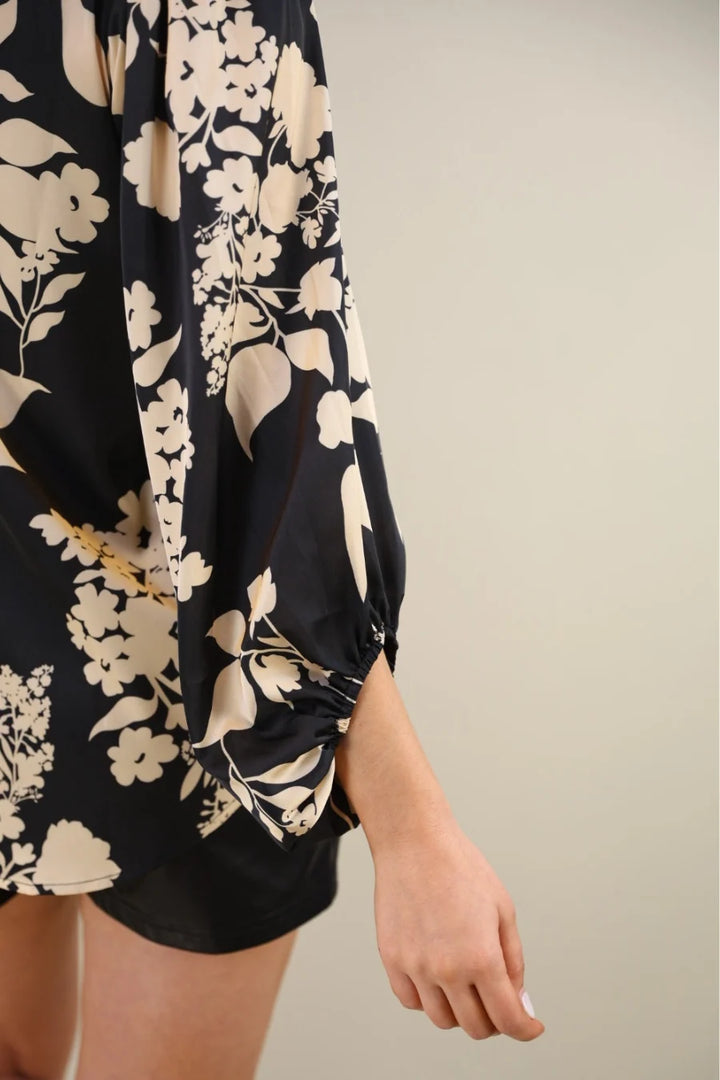 Close- up of a black floral blouse and sleeve