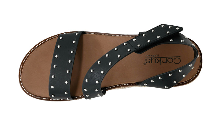 Black sandal with metal studs on a white background