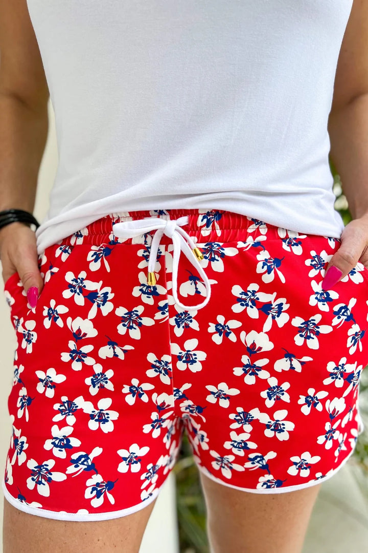 A zoomed in image of a women wearing the shorts with her shirt tucked in with both hands in her pockets