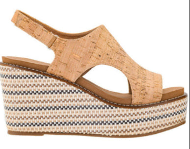 Woven wedge sandal with cork wedge on a white background