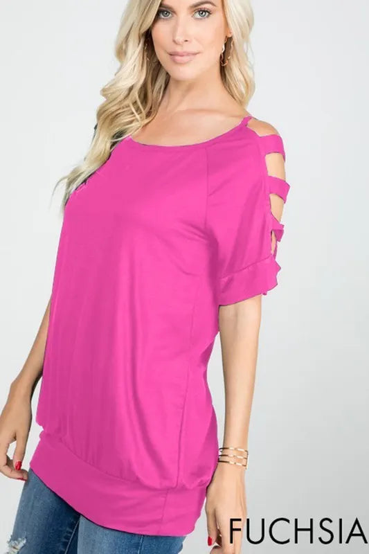 Woman wearing a bright pink top with cut-out shoulders on a white background
