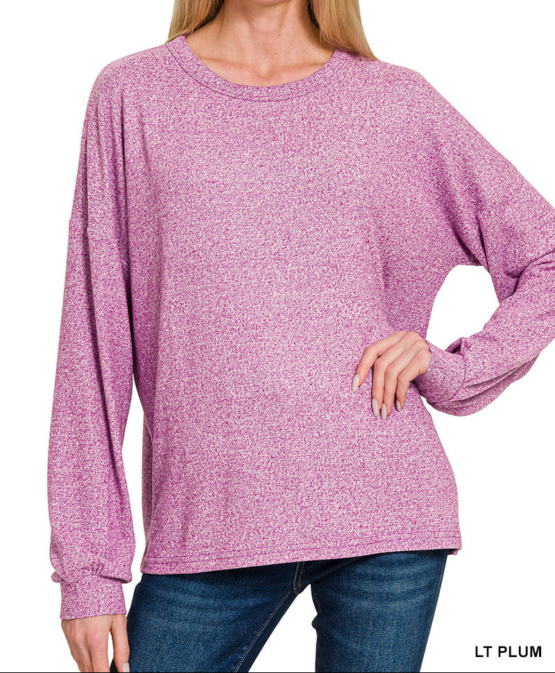 Woman wearing light plum top and jeans