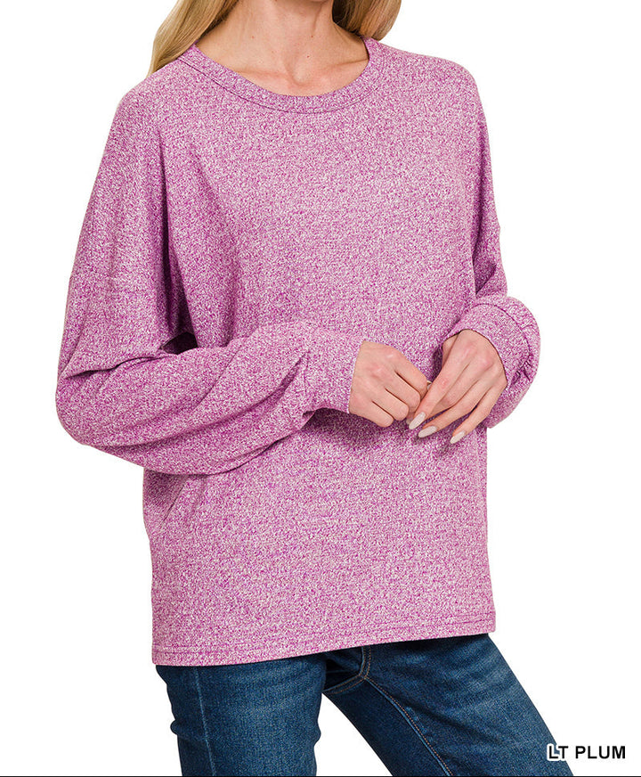 Woman wearing light plum top and jeans