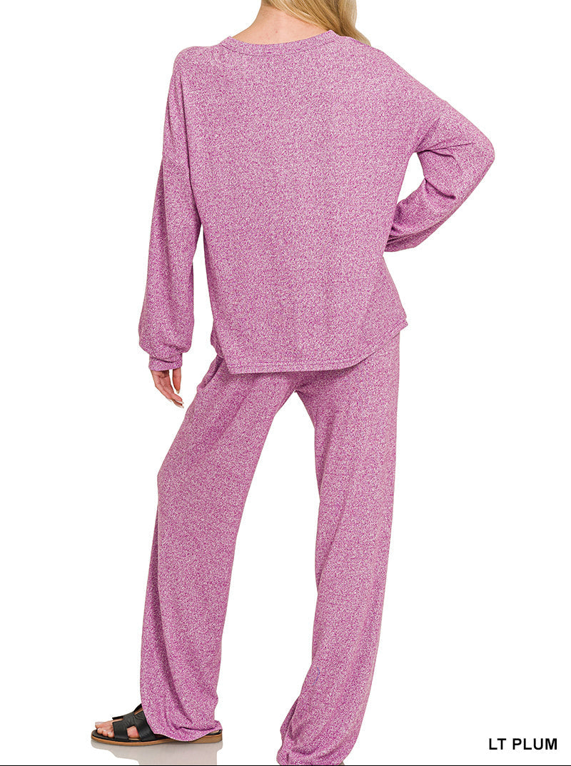 Woman wearing a light plum top and bottom set, looking at the wall