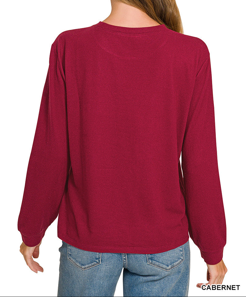 Woman facing backwards wearing a top and jeans