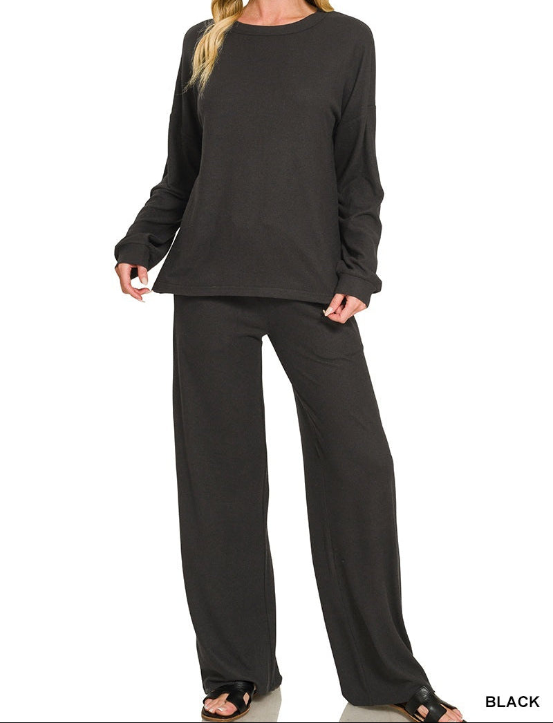 Woman wearing a black top and pants set