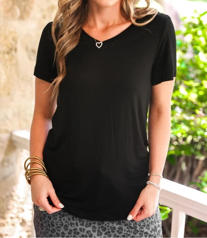 Woman wearing a black, v neck tee and black leopard print skort