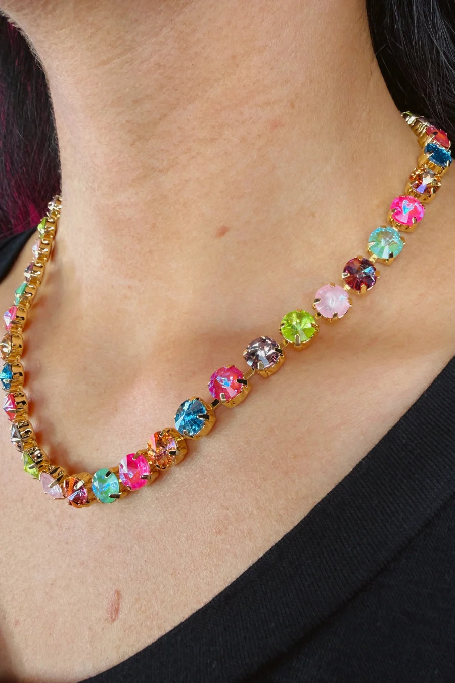 Woman wearing multicolored gemstones necklace