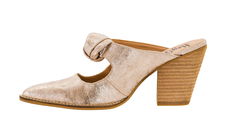 Gold high-heeled shoe with a knot on a white background