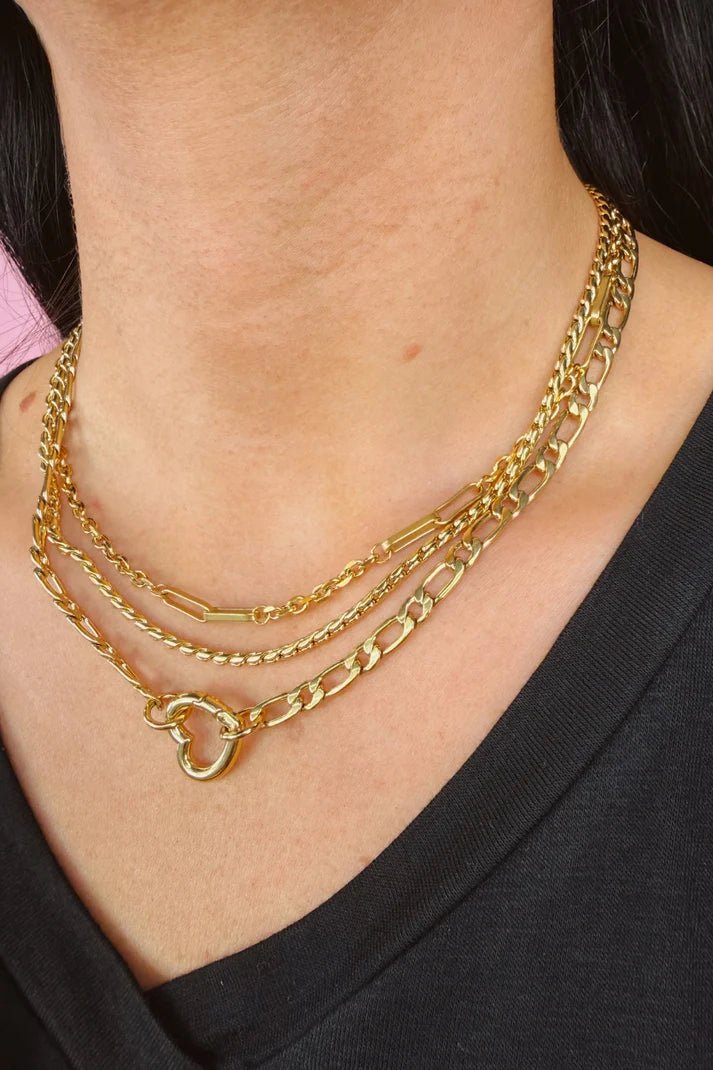 Woman wearing a triple chain necklace.