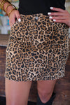 Leopard print skirt worn by a person with a blurred background