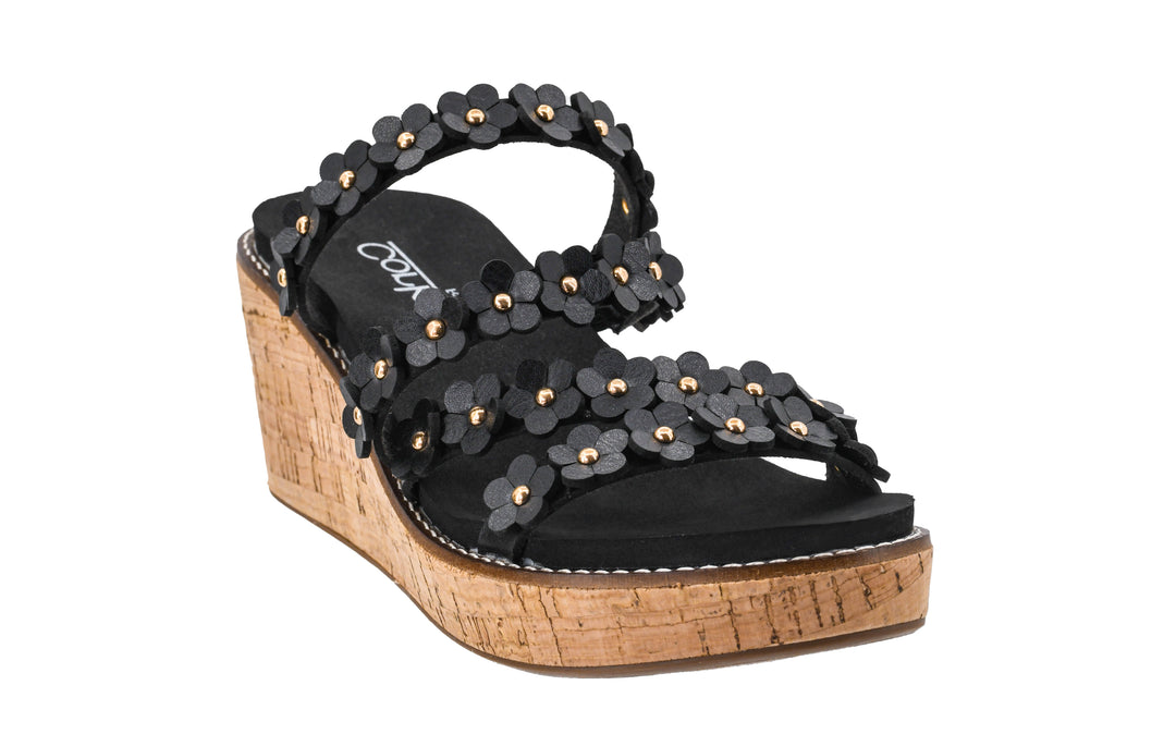 Black wedge sandal with floral embellishments on a white background