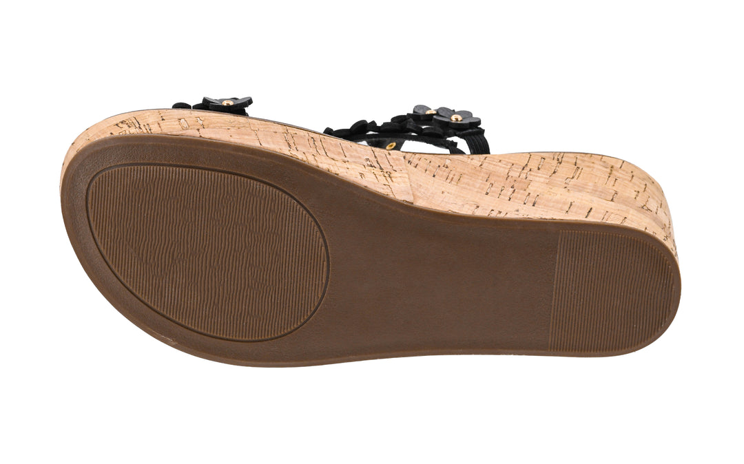 Close-up of a sandal sole with cork texture and brown insole on a white background