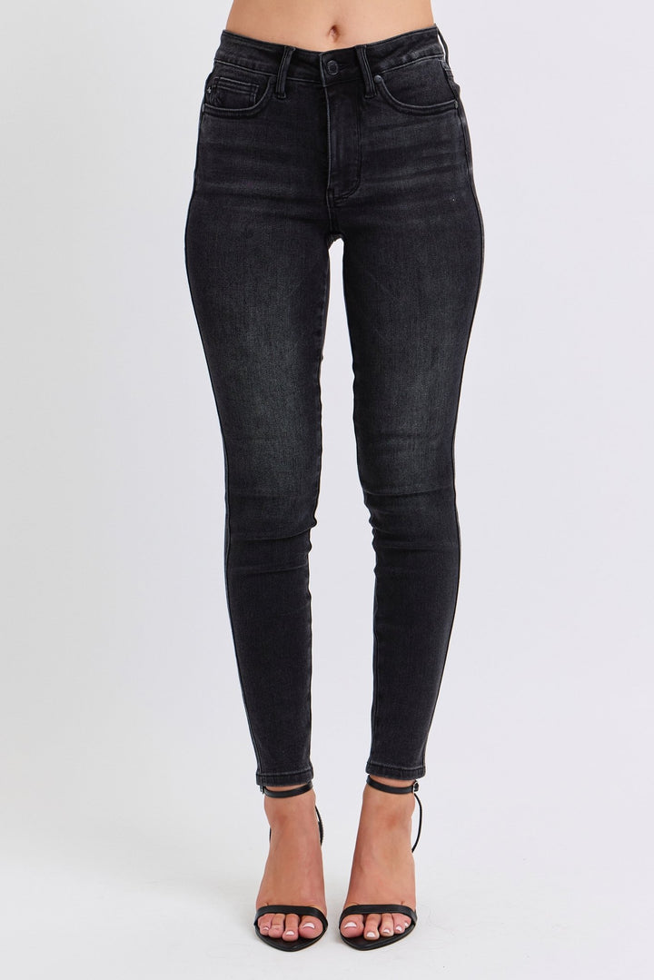 Woman wearing black skinny jeans with white background. Judy Blue Jeans (NP) - Mid Rise Tummy Control Skinny - black | Nikki &amp; Co. Boutique