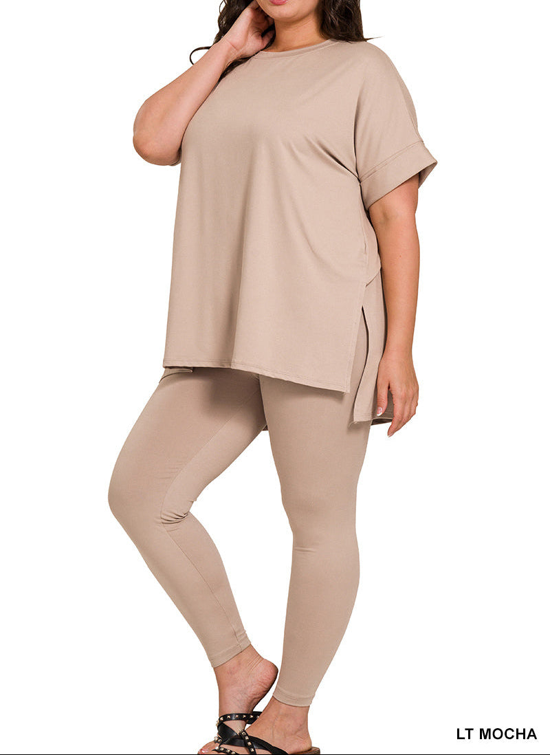 A woman modeling a matching two-piece lounge set in light mocha, featuring a short-sleeve crewneck top and high-waisted leggings, shown against a plain white background.