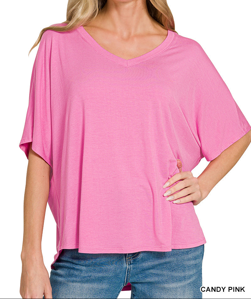 Woman wearing a pink v neck top and jeans