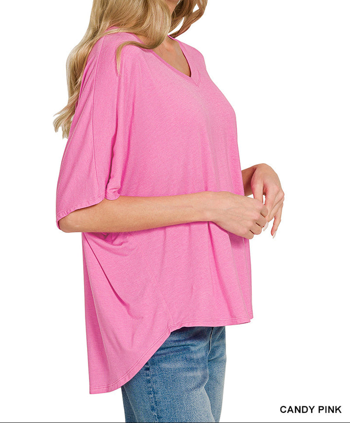Woman wearing a pink v neck top and jeans