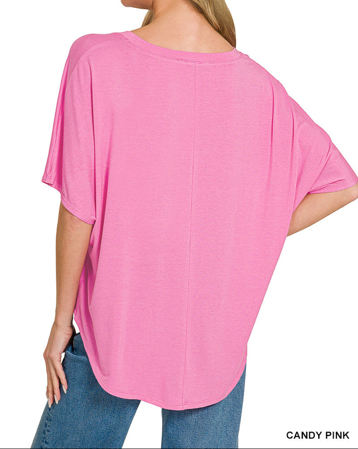 Woman wearing a pink v neck top and jeans