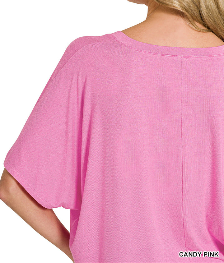 Woman wearing a pink top, back view