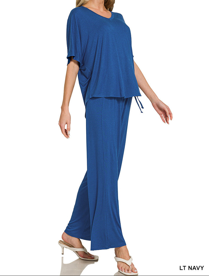 Woman wearing a v-neck oversized top &amp; pants set