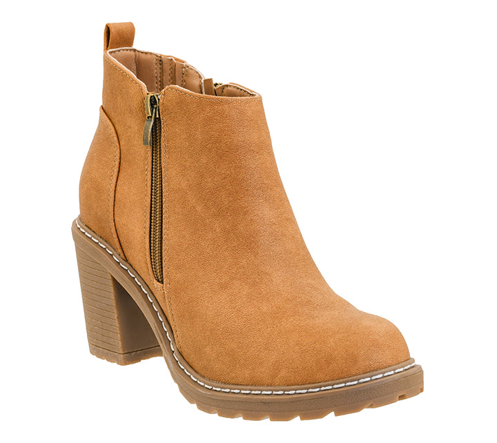 A tan suede ankle boot with a block heel, side zipper, and white contrast stitching, shown on a plain white background.