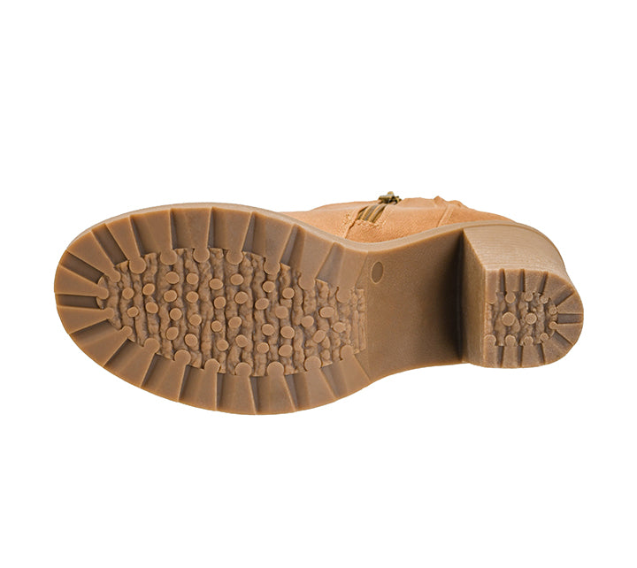 A top-down view of a tan suede boot showing its brown textured rubber sole against a plain white background.