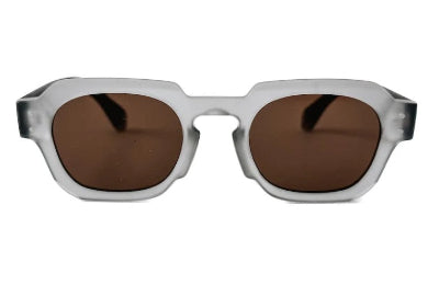 Sunglasses with brown lenses and clear frame on a white background