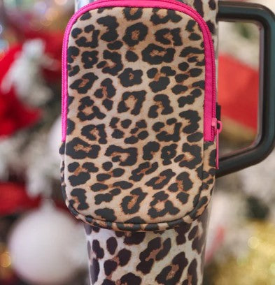 Leopard print phone case with pink zipper on a blurred background