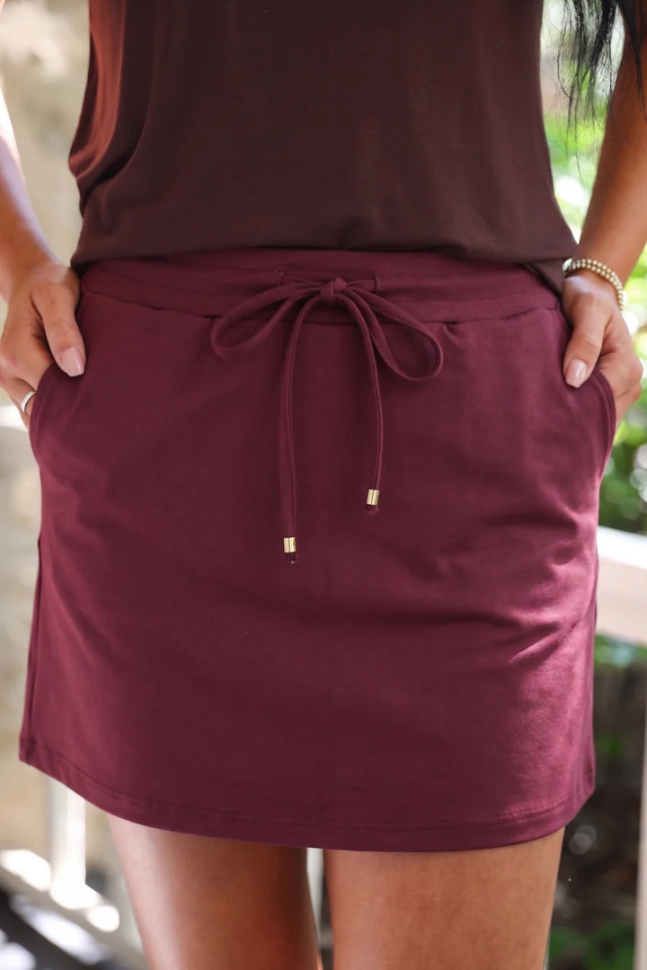 Burgundy skort worn by a person standing.