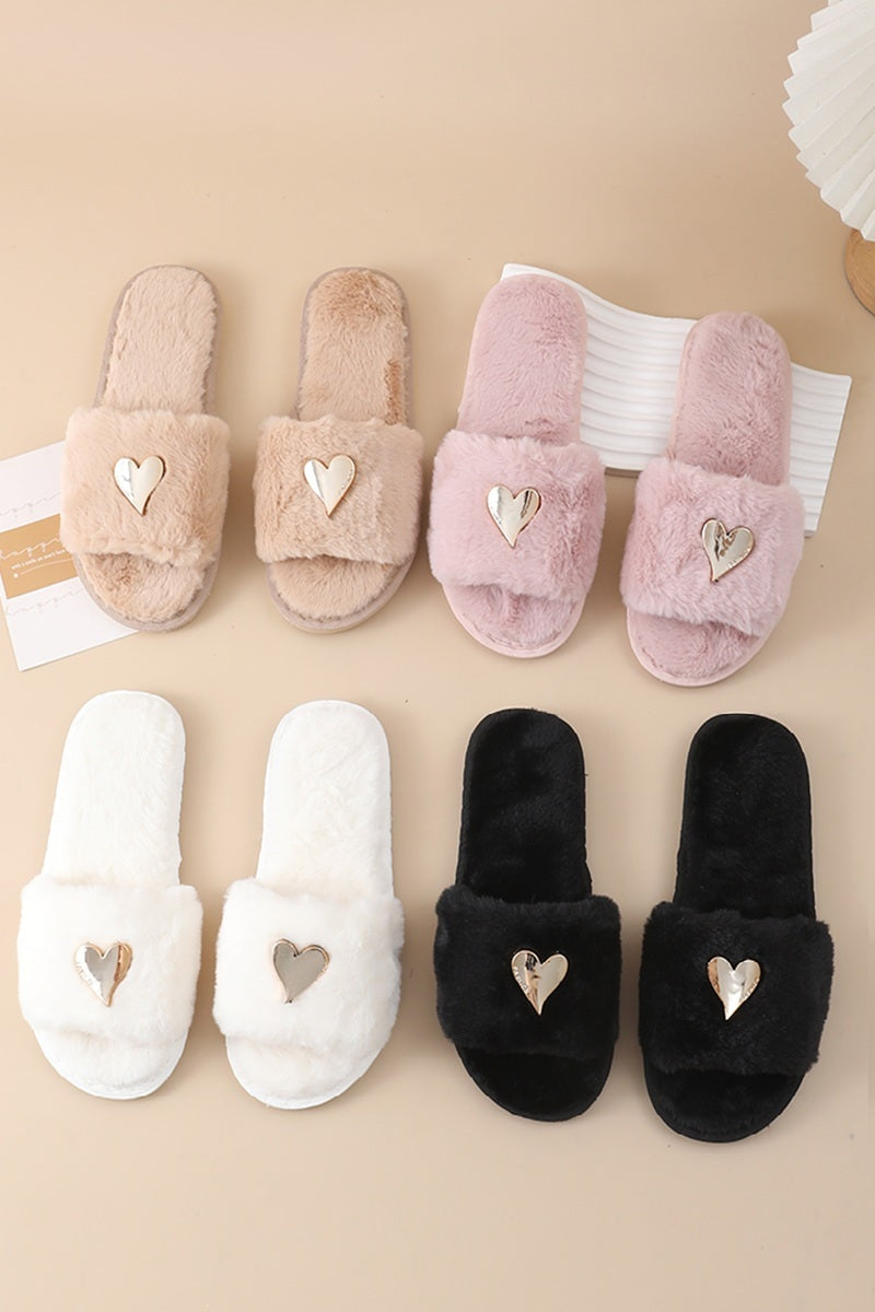 Four pairs of fuzzy open-toe slippers arranged in a 2x2 grid on a beige background. The top row shows beige and light pink slippers, and the bottom row shows white and black slippers.
