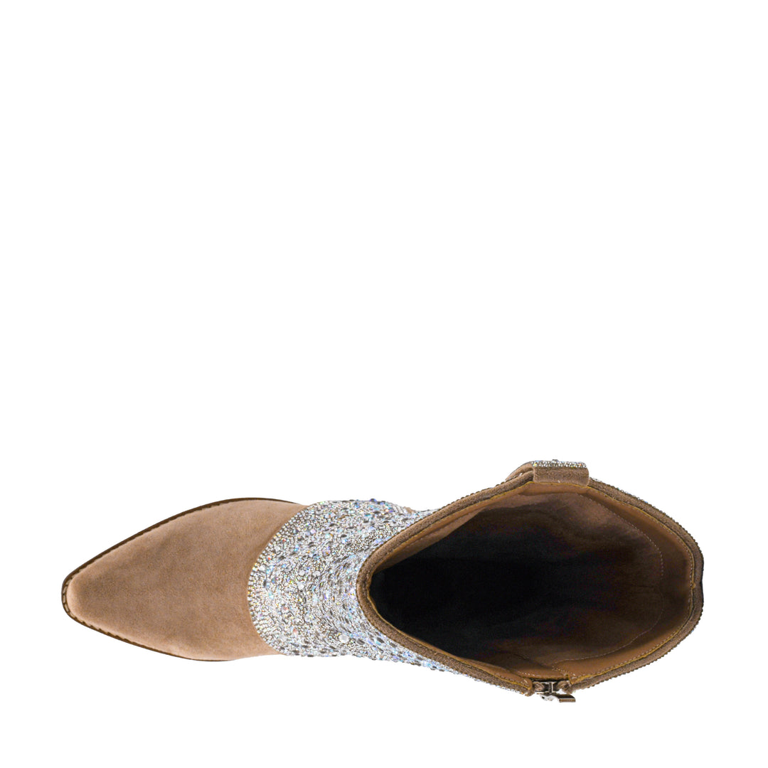 Top-down view. A single western-style cowboy boot with a beige suede foot and stacked block heel, covered in sparkling rhinestone embellishments on the shaft, and featuring a central zipper, shown against a plain white background.