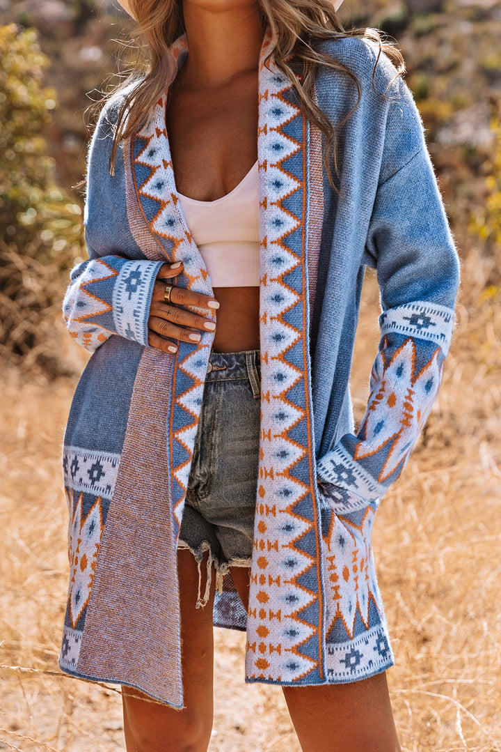 Person wearing a blue patterned cardigan in an outdoor setting