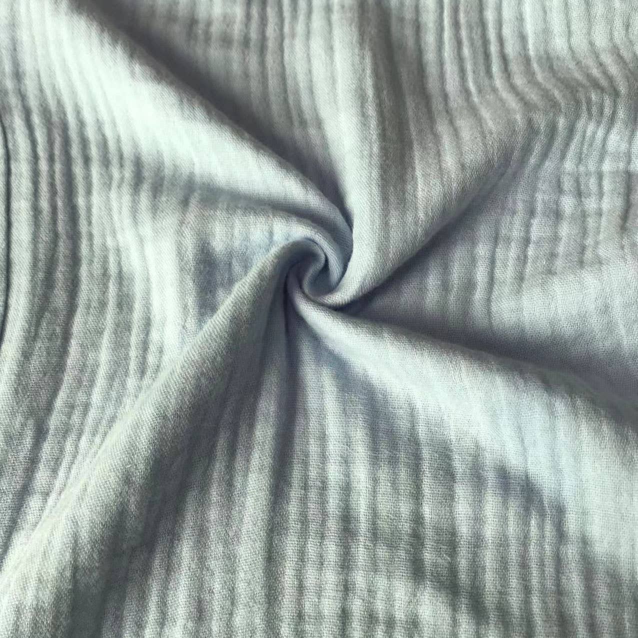 Close-up of textured gray fabric with folds