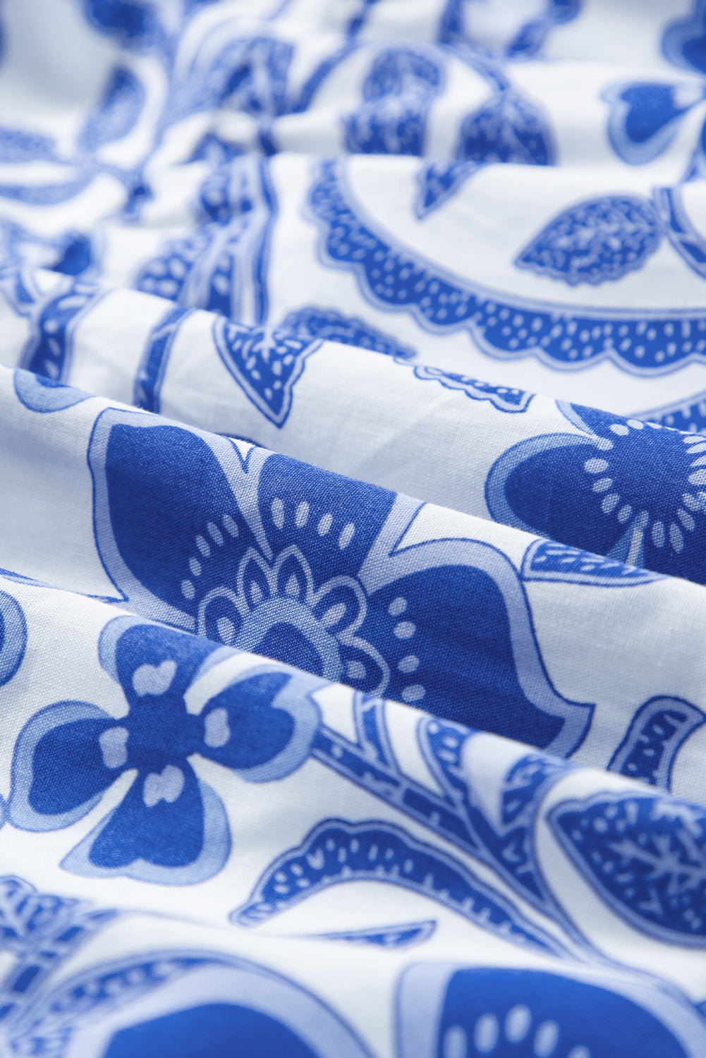 Close-up of blue floral pattern on white fabric