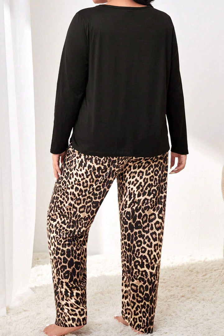 Person wearing a black long-sleeve top and leopard print pants on a white background
