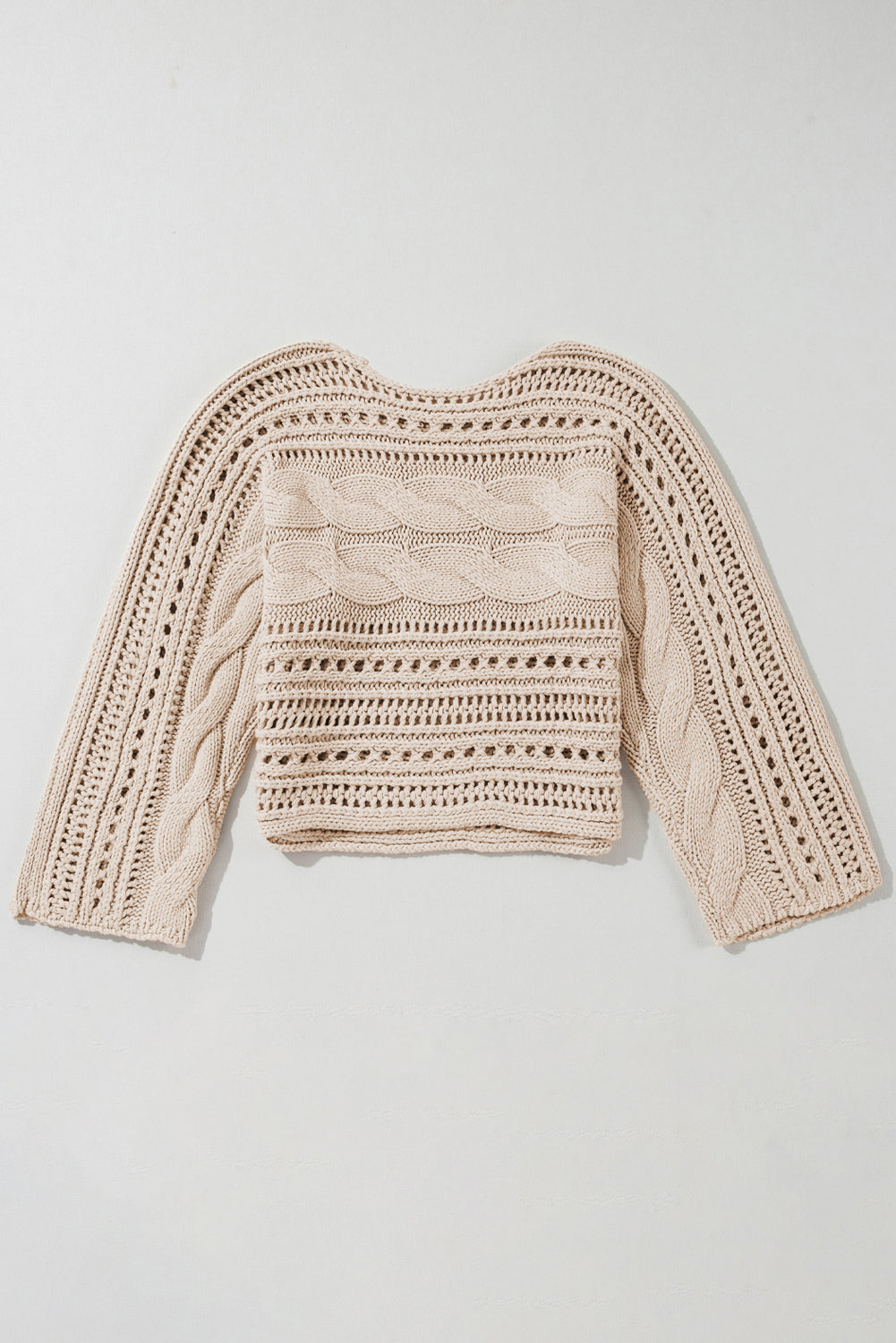 Beige knitted sweater on a light gray background