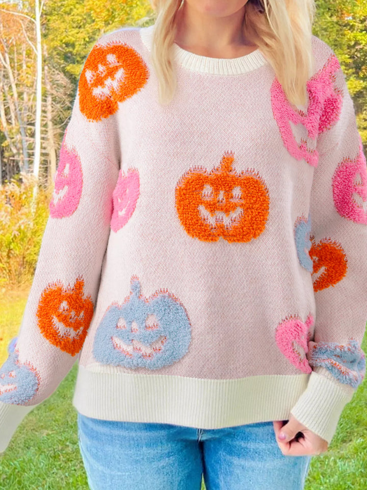 Women wearing dusty pink sweatshirt with blue pink and orange pumpkins on it