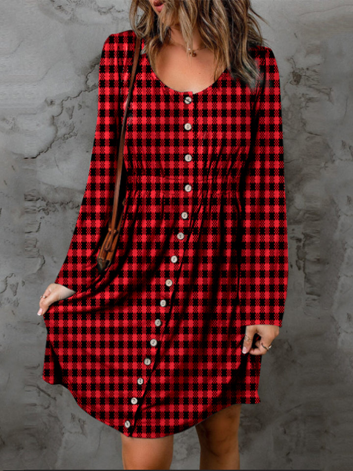 Red and black checkered dress with long sleeves on a textured gray background