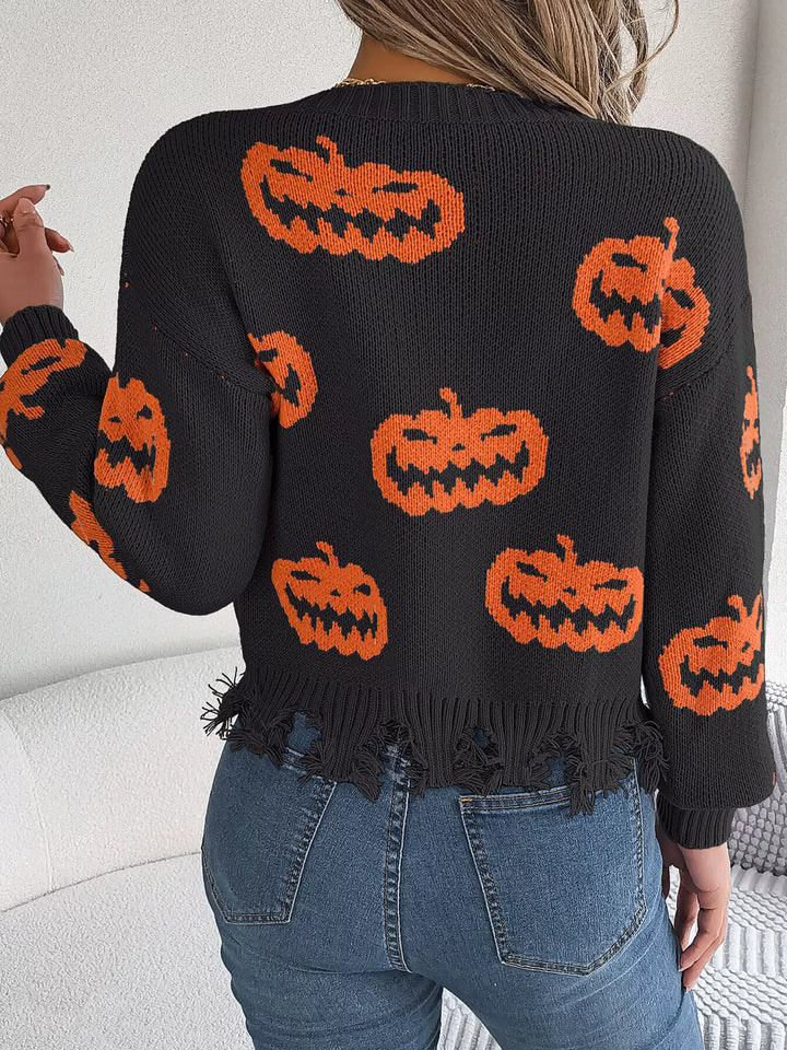 Women wearing black sweater with pumpkins on it while facing a wall