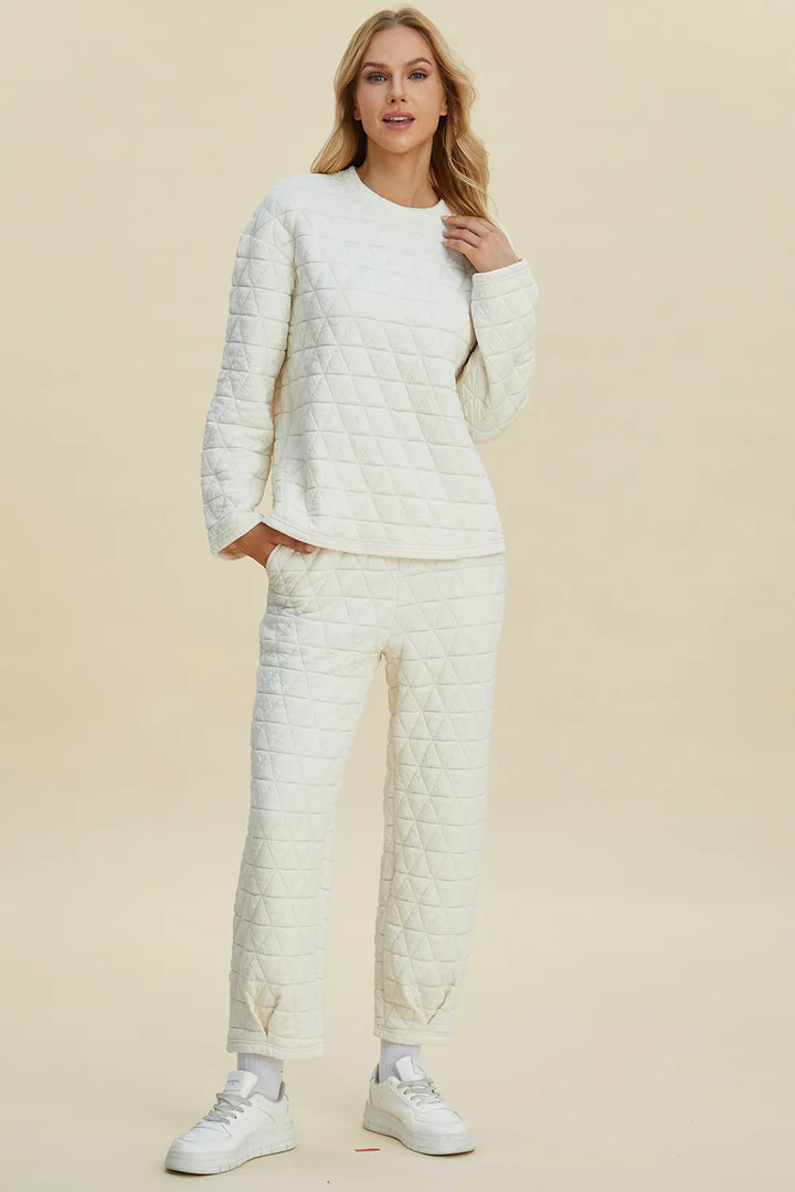 Woman wearing a matching quilted outfit with a beige background