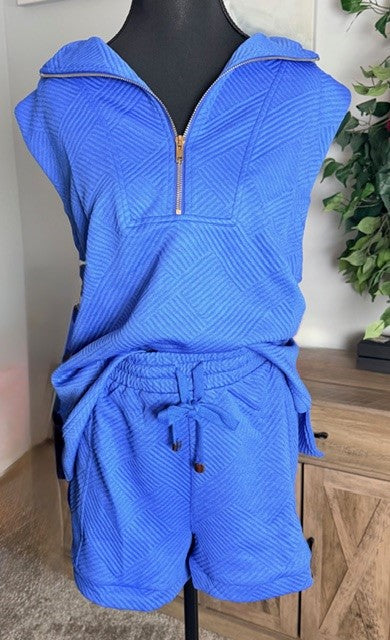 Blue textured outfit on a mannequin with a neutral background