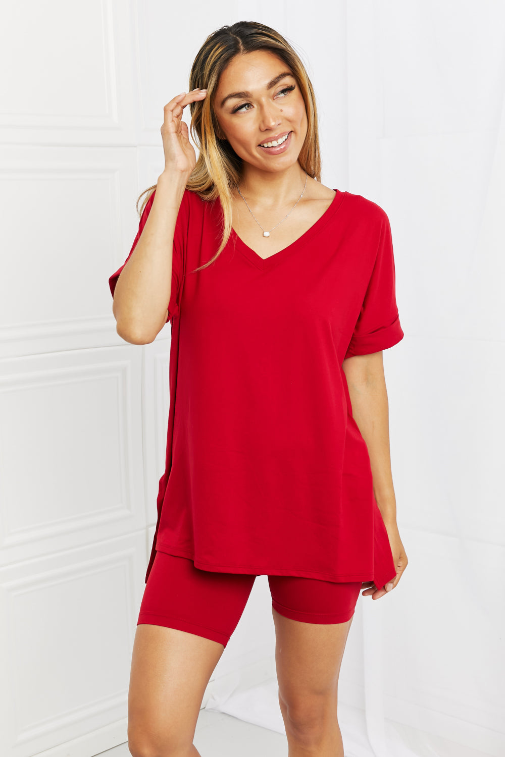 Woman wearing a burgundy outfit against a white background